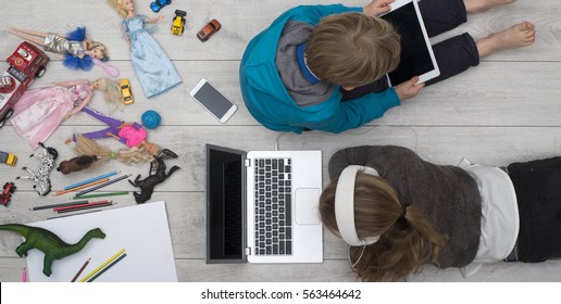 Spoiled Kids Behind Tablet And Computer