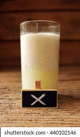 Spoiled Milk In Glass And Small Wooden With Remark Unable Drink  , Concept Healthy And Be Careful.