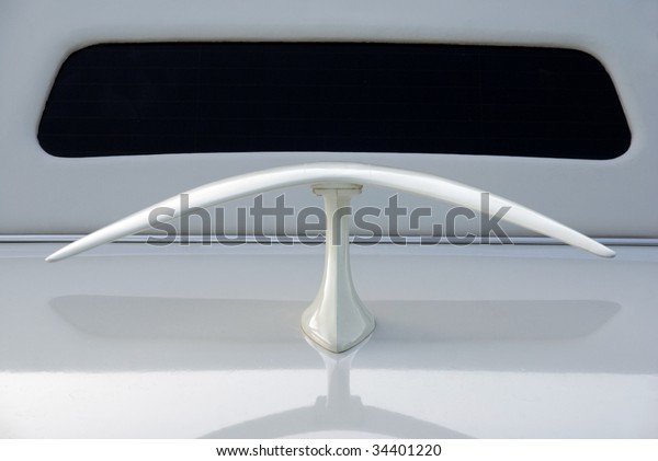 Spoiler at the rear of a\
white limousine