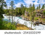 The Spokane River as it flows through the Falls Park forest area near the dam in the rural city of Post Falls, in the Coeur d