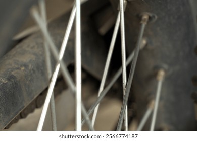 The spokes of a motorcycle wheel. The repeating pattern and radial arrangement of the spokes create an interesting visual.