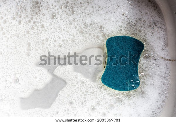 Sponge with bubbles in the\
sink.