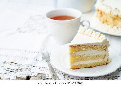 Sponge cake with butter cream on a white background. the toning. selective focus