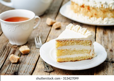 Sponge cake with butter cream on a dark wood background. the toning. selective focus
