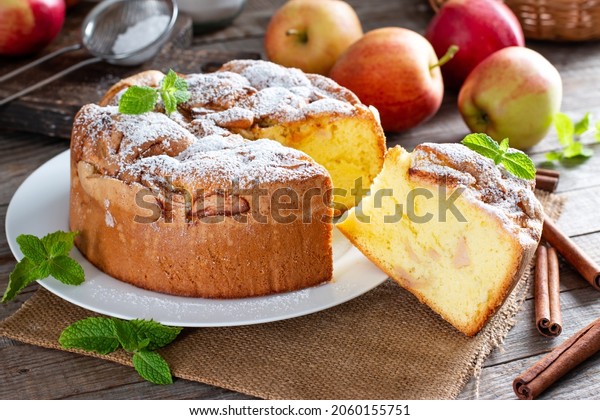 Sponge cake or\
chiffon cake with apples, so soft and delicious with ingredients:\
eggs, flour, apples on wooden table. Homemade bakery concept for\
background and\
wallpaper.