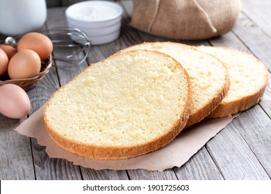 Sponge Cake Or Chiffon Cake, So Soft And Delicious With Ingredients: Eggs, Flour, Milk On Wood Table. Homemade Bakery Concept For Background And Wallpaper.