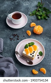 Schwammkuchenschichten mit Buttercreme, verziert mit Scheiben aus Tangerine Schokolade und Minze. Lecker süßer Nachtisch für Tee
