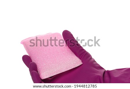 Sponge for washing and cleaning in female hand. Hand in a latex glove isolated on white. A hand in a glove holds a sponge for washing and cleaning.