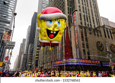 Spongebob Squarepants balloon floats in the air during Macy's Thanksgiving Day parade along Avenue of Americas with the Radio Music Hall in the background. Manhattan, New York, USA November 27, 2014