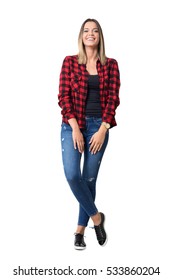 Spontaneously laughing relaxed young pretty casual woman in jeans and plaid shirt. Full body length standing portrait isolated over white background. 
