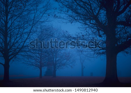 Spooky battlefield in Gettysburg, PA in silhouette with mist and fog