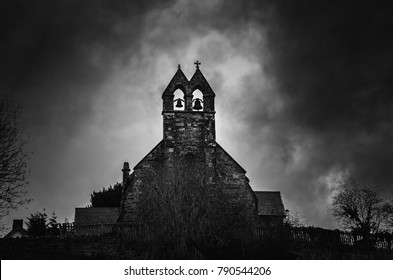 Spooky Church Bells At Night With Moonlight Behind. St Thomas Church, Halford, Craven Arms, Shropshire, England, UK. 