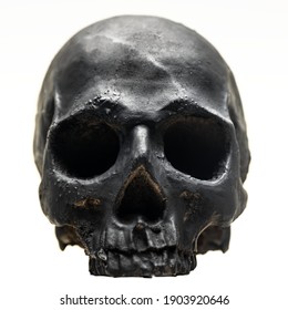 Spooky dark black skull aginast white background closeup