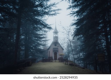 Spooky foggy dark forest scene with a path ending on a lonely creepy old abandoned chapel - Powered by Shutterstock