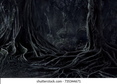 Spooky Halloween dead mysterious forest creepy trees with twisted roots and two lizard on misty night forest. Scary concept.
