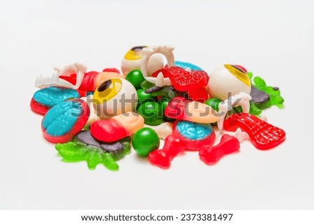 Spooky Halloween Sweets: Jelly Finger, Eyeball, Spider, Brain, Tongue, and Bone Candies on White Background