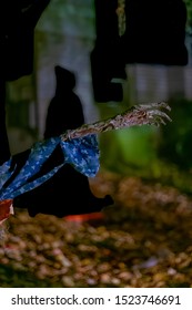 A Spooky Scene From The Brandy Wine Cemetary With A Close-up Of A Skeleton Hand And Dark Figure