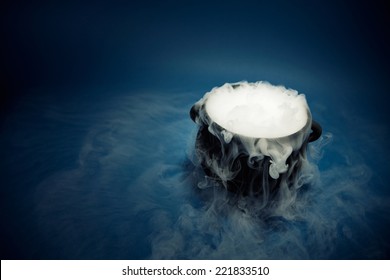 A Spooky Witch's Cauldron With Smoke Coming Out.