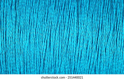Spool of blue thread macro texture