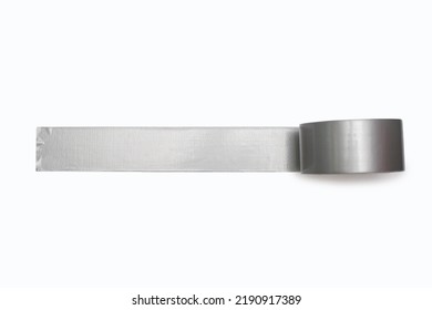 A spool of gray duct tape is unwound and pasted to a white background. Adhesive tape for repair work and construction. Adhesive tape for moisture protection or for assembly and packaging