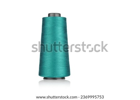 spool of industrial threads blue colors, texture of threads on a white background close-up