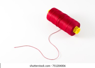Spool of red thread isolated on white background