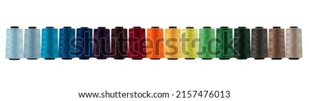Spool of sewing thread, isolated on white background. Colored yarns used by factories in the clothing industry. Threads wound on the spool. Colored reels	