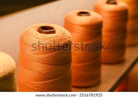 Spool of sewing thread, isolated on white background. Colored yarns used by factories in the clothing industry. Threads wound on the spool. Colored reels