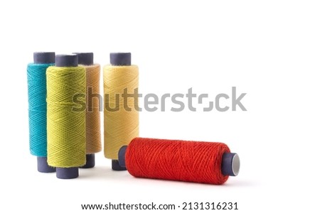 spool of sewing thread used in fabric and textile industry, different colors, isolated on white background