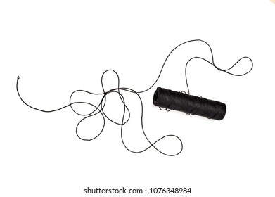 Spool And Tangled Black Thread Isolated On White Background.