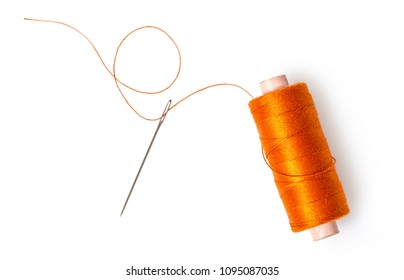 spool of thread with a needle on white isolated background - Shutterstock ID 1095087035