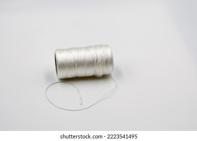 Spool Of White Thread Closeup On White