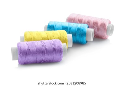 Spools of bright sewing threads isolated on white
