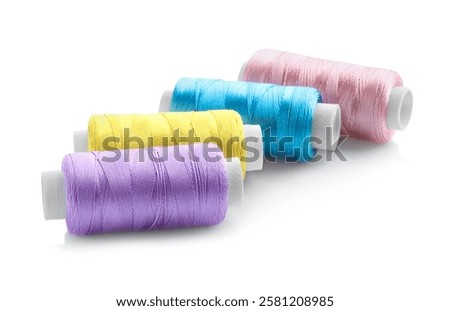 Spools of bright sewing threads isolated on white