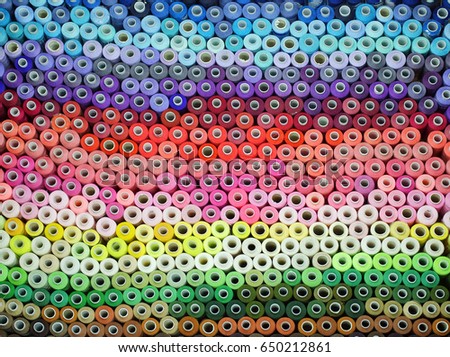 Spools of colored sewing thread         