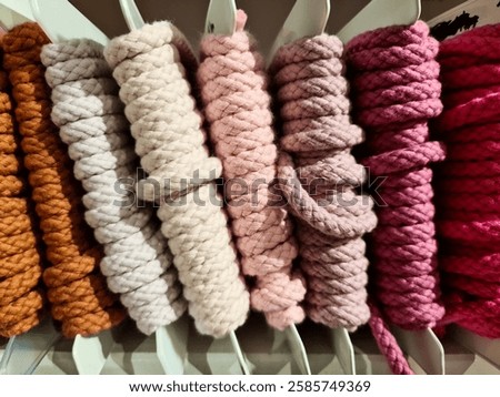 Similar – Image, Stock Photo Vibrant orange yarn spools in industrial setting