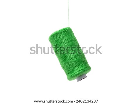 spools of greencolor  sewing cotton floating