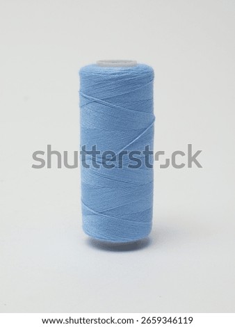 Spools of Sewing Thread on grey background