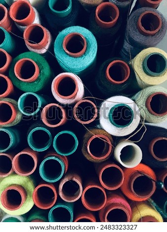 spools of sewing thread are placed in a small box, and various types of colours can be used as a background and look abstract
