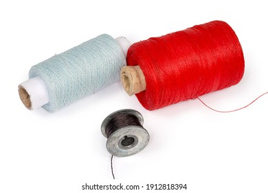 Spools Of Threads Different Colors And Black Thread On A Metal Bobbin Of A Domestic Sewing Machine On A White Background 
