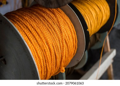 Spools of yellow polyethylene nylon ropes for sale at a fishing supply store.