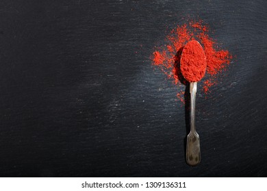 Spoon With Chilli Powder On Dark Background, Top View