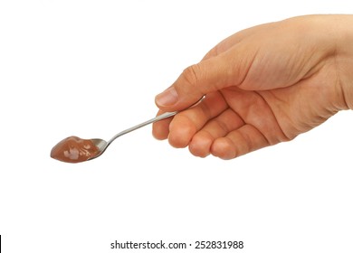 Spoon With Chocolate Pudding, Coffee, Baby Food In Hand On A White Background