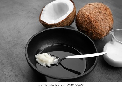 Spoon with coconut oil on frying pan - Shutterstock ID 610155968