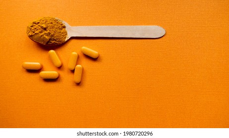 Spoon With Curcumin Powder And Curcumin Capsules Top View