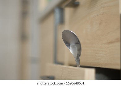 Spoon in the drawer . Kitchen interior 