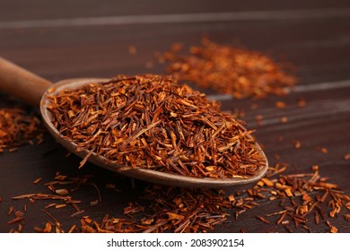 Spoon With Dry Rooibos Leaves On Wooden Table, Closeup