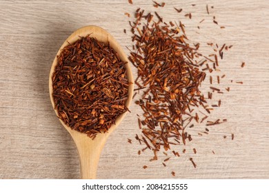 Spoon With Dry Rooibos Leaves On Wooden Table, Flat Lay