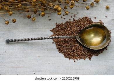 Spoon Filled With Linseed Oil. Flax Seeds On A Linen Canvas Background.