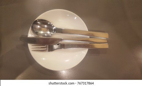 Spoon fork and knife on dish